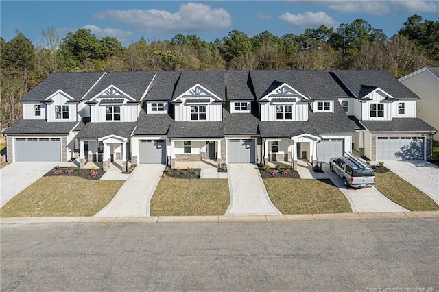 townhome / multi-family property with driveway, a front yard, and a residential view