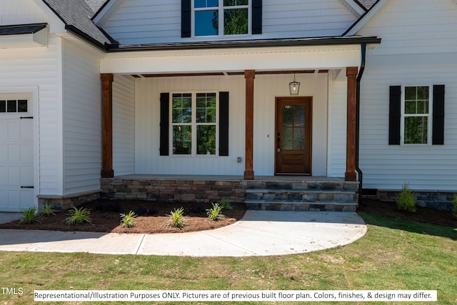 view of exterior entry with a garage and a porch