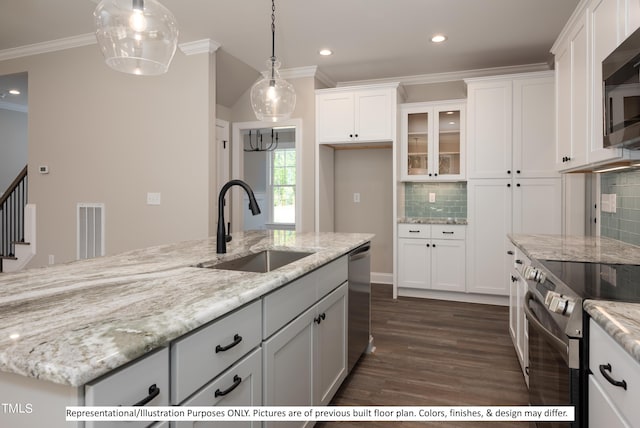 kitchen with tasteful backsplash, appliances with stainless steel finishes, sink, and white cabinetry