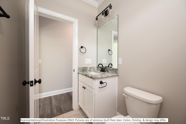 bathroom featuring wood-type flooring, crown molding, vanity, and toilet