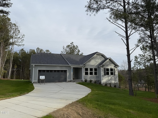 view of front of house with a garage and a front lawn