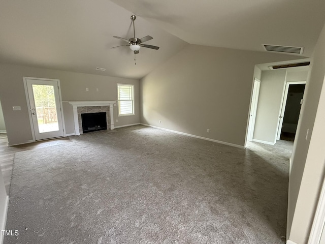 unfurnished living room with a premium fireplace, lofted ceiling, carpet floors, and ceiling fan