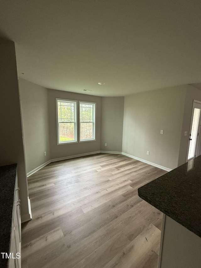 unfurnished living room featuring light hardwood / wood-style flooring