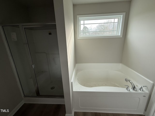 bathroom featuring separate shower and tub