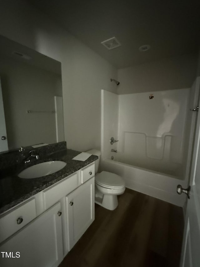 full bathroom featuring bathtub / shower combination, vanity, toilet, and hardwood / wood-style floors