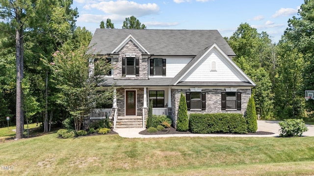 craftsman inspired home featuring a front yard and a porch