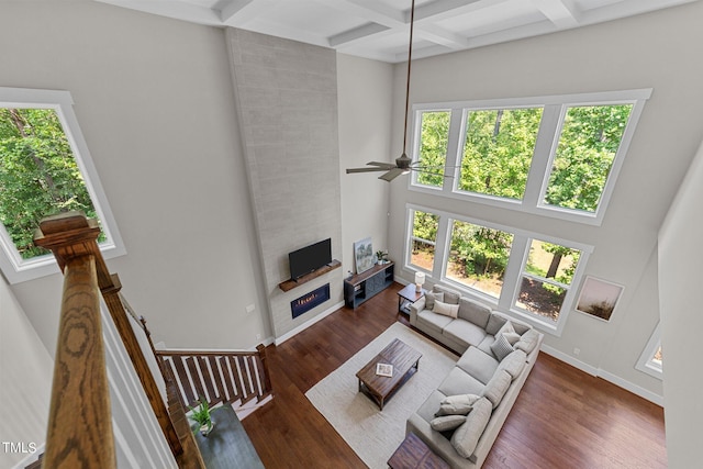 living room featuring a fireplace, a healthy amount of sunlight, and ceiling fan