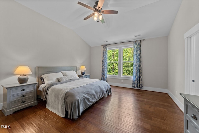 bedroom with vaulted ceiling, dark hardwood / wood-style flooring, and ceiling fan