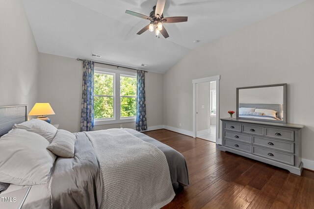 bedroom with lofted ceiling, ceiling fan, ensuite bathroom, and dark hardwood / wood-style flooring