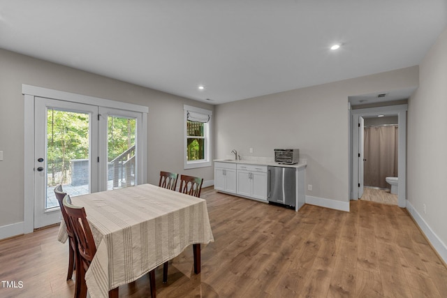 dining space featuring light hardwood / wood-style floors and sink