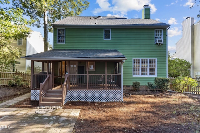 rear view of property with a sunroom and cooling unit