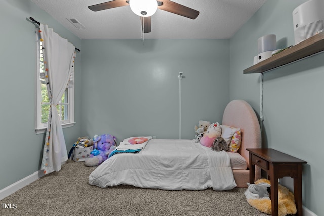 bedroom with carpet flooring, a textured ceiling, and ceiling fan