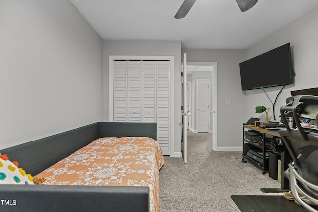 carpeted bedroom with a closet and ceiling fan