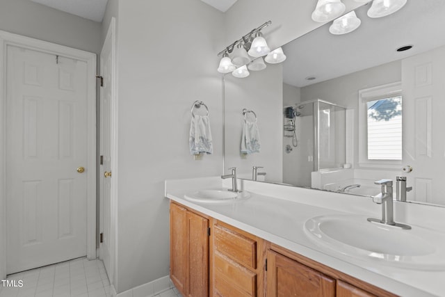 bathroom featuring tile patterned floors, a shower with door, and vanity