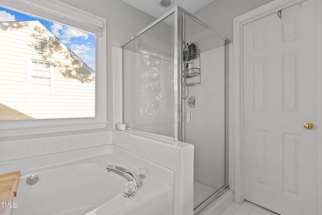 bathroom with tile patterned floors and independent shower and bath