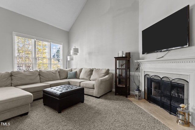 carpeted living room featuring high vaulted ceiling