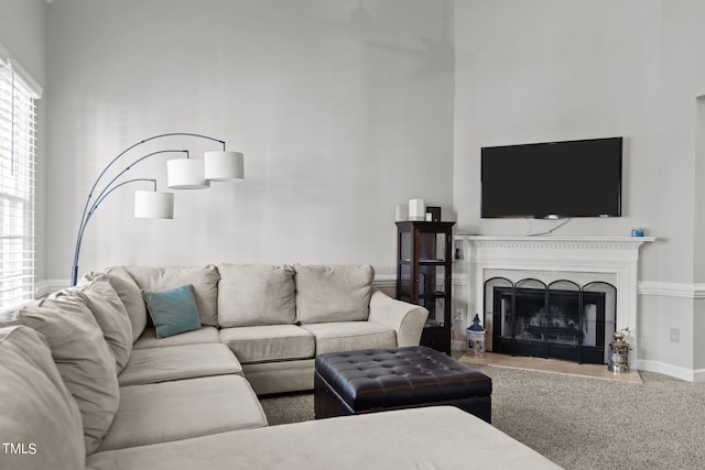 carpeted living room with a high ceiling