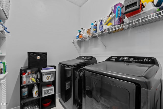 clothes washing area with washer and clothes dryer