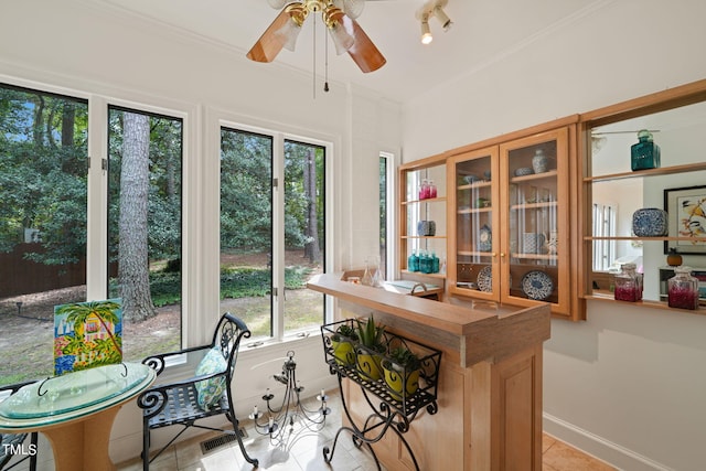 office with crown molding, plenty of natural light, light tile patterned floors, and ceiling fan