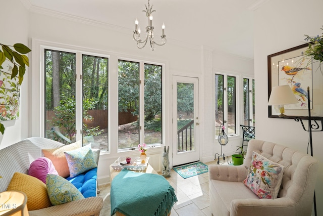 sunroom / solarium with plenty of natural light and a chandelier