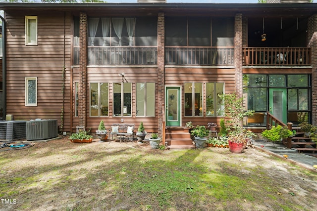 rear view of house with central AC and a balcony