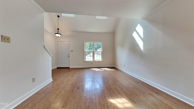 interior space with vaulted ceiling and light hardwood / wood-style flooring