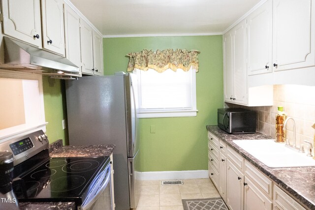 kitchen featuring electric range, white cabinetry, sink, light tile patterned flooring, and decorative backsplash