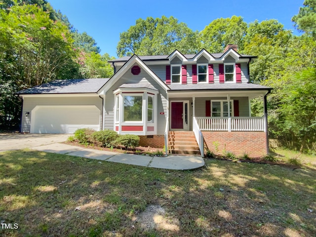 view of front facade with a garage, a porch, and a front yard