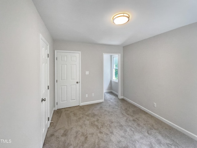 unfurnished bedroom featuring light colored carpet