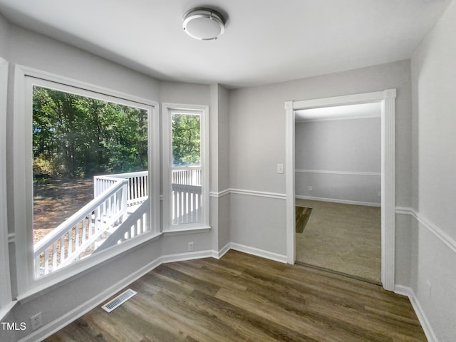 unfurnished room with dark hardwood / wood-style flooring