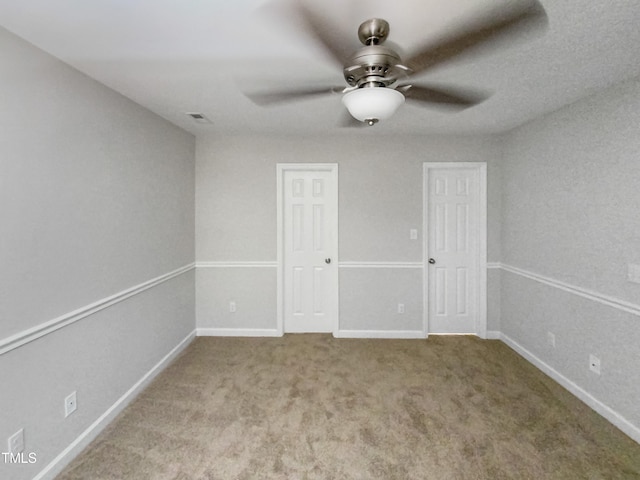 carpeted empty room with ceiling fan