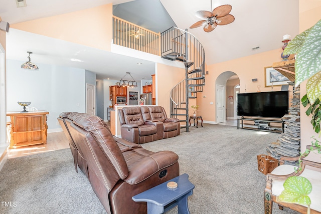 living room with high vaulted ceiling, light colored carpet, and ceiling fan