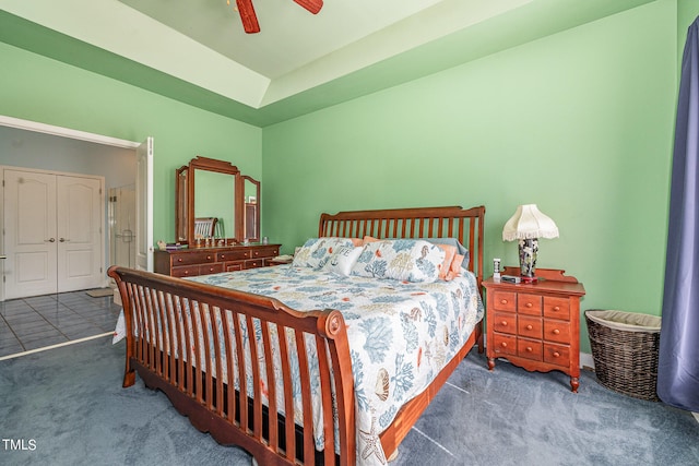 carpeted bedroom featuring ceiling fan and a closet