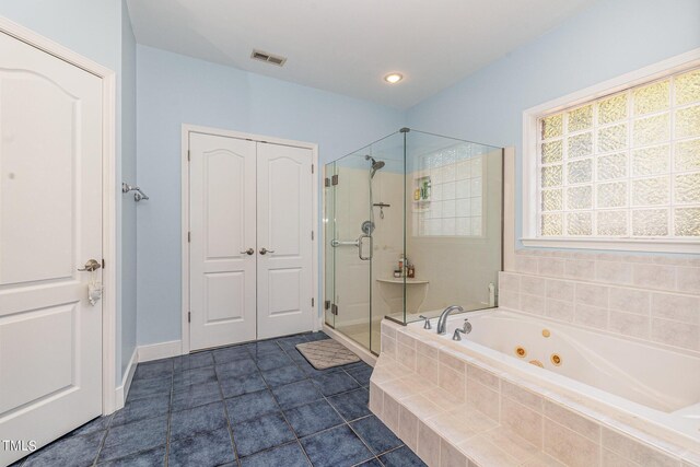 bathroom featuring independent shower and bath and tile patterned flooring