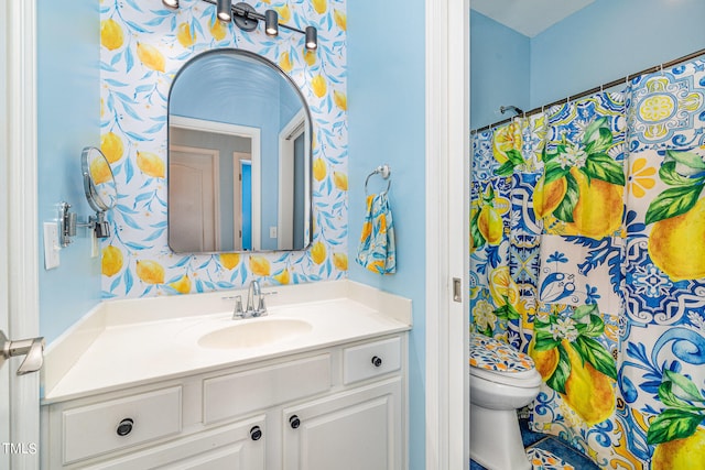 bathroom featuring toilet and vanity