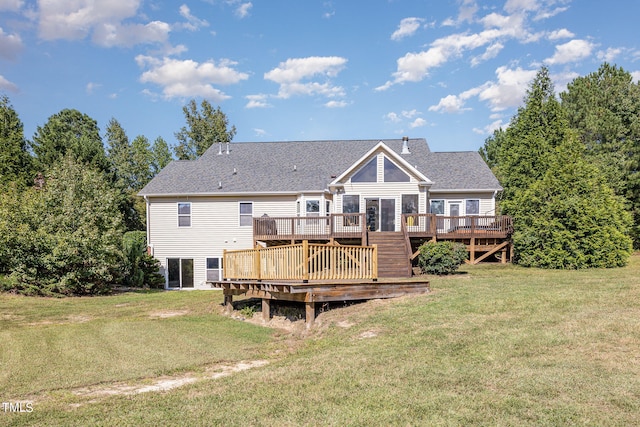 rear view of house with a deck and a lawn