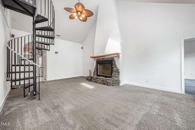 3313 Overhead Ct, Willow Springs, NC 27592 - unfurnished living room with high vaulted ceiling, carpet flooring, stairs, a ceiling fan, and a stone fireplace