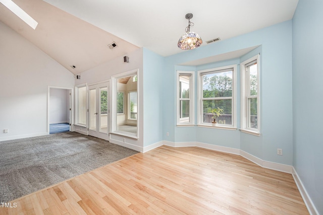 3313 Overhead Ct, Willow Springs, NC 27592 - unfurnished living room with a skylight, light wood finished floors, and lofted ceiling