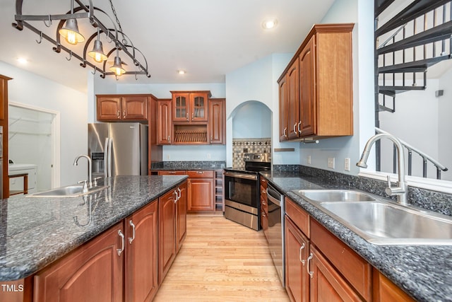 3313 Overhead Ct, Willow Springs, NC 27592 - kitchen with stainless steel appliances, light wood-style floors, recessed lighting, glass insert cabinets, and brown cabinetry