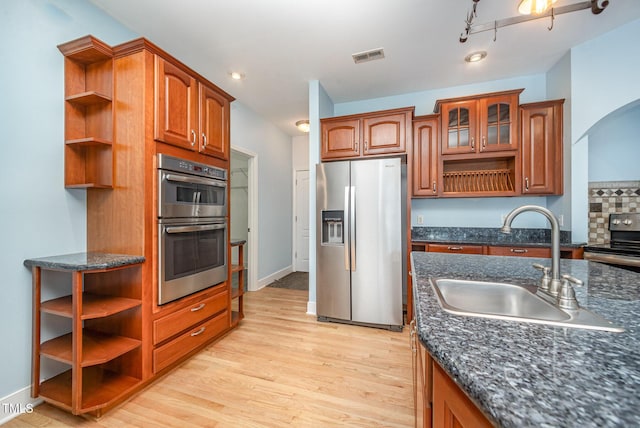 3313 Overhead Ct, Willow Springs, NC 27592 - kitchen with open shelves, stainless steel appliances, arched walkways, light wood-type flooring, and recessed lighting