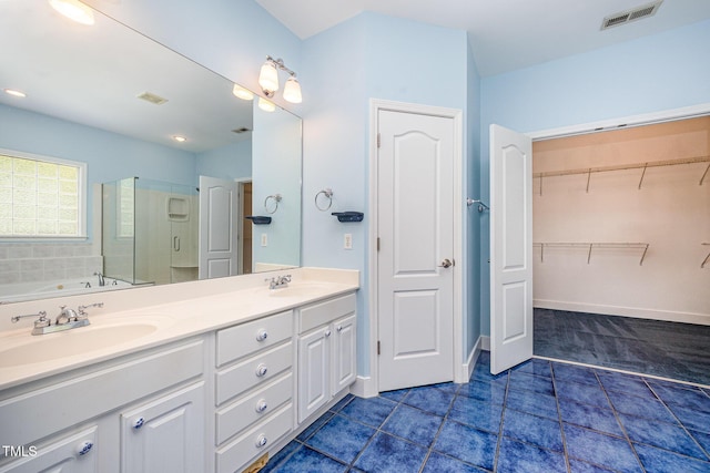 3313 Overhead Ct, Willow Springs, NC 27592 - full bath featuring a stall shower, tile patterned floors, double vanity, a garden tub, and a spacious closet
