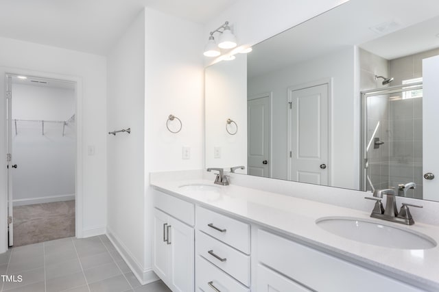 full bath with visible vents, a stall shower, and a sink