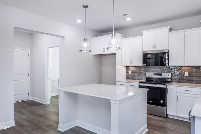 kitchen with visible vents, stainless steel appliances, dark wood-type flooring, light countertops, and backsplash