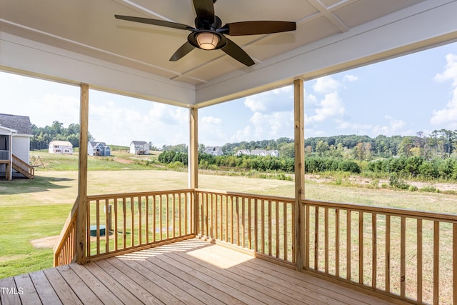 deck featuring ceiling fan and a yard