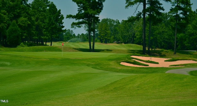 view of home's community with a lawn and golf course view