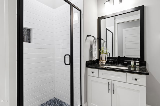 bathroom featuring walk in shower and vanity