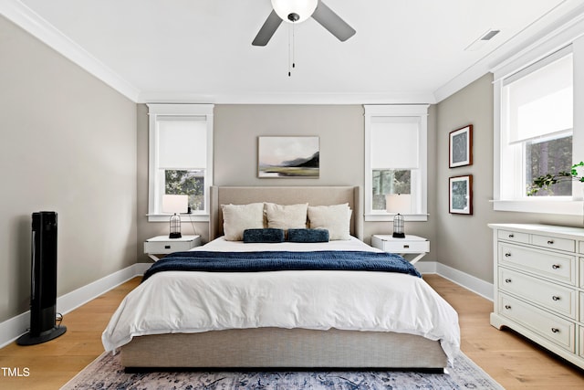 bedroom with ceiling fan, light hardwood / wood-style flooring, crown molding, and multiple windows