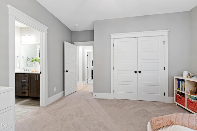 bedroom featuring a closet and light colored carpet