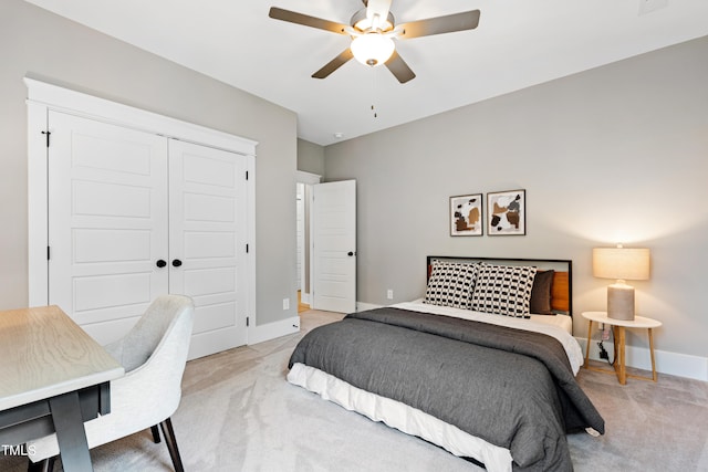 bedroom featuring a closet, ceiling fan, and light colored carpet