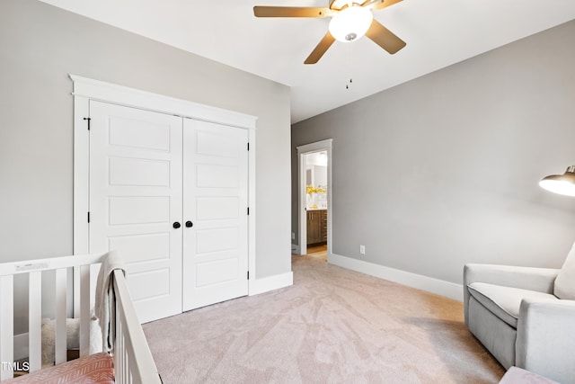 bedroom with light carpet, a closet, and ceiling fan